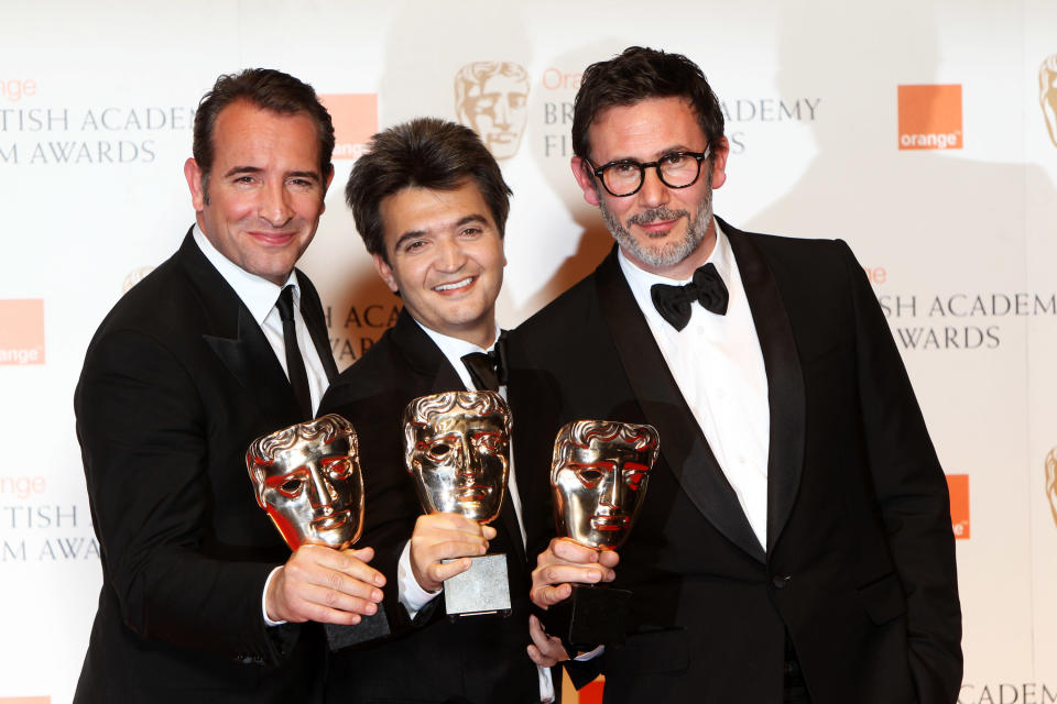 LONDON, ENGLAND - FEBRUARY 12: (UK TABLOID NEWSPAPERS OUT) L-R Jean Dujardin, Thomas Langmann and Michel Hazanavicius pose with their awards for The Artist in the press room at The Orange British Academy Film Awards 2012 at The Royal Opera House on February 12, 2012 in London, England. (Photo by Dave Hogan/Getty Images)