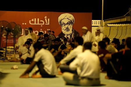 A banner with a picture of Bahrain's leading Shi'ite cleric Isa Qassim is seen as supporters gather during a sit-in outside his home in the village of Diraz west of Manama, Bahrain July 27, 2016. REUTERS/Hamad I Mohammed