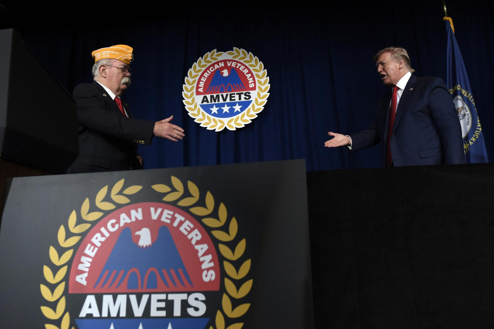 President Donald Trump greets AMVETS national commander Rege Riley at the American Veterans (AMVETS) 75th National Convention in Louisville, Ky., Wednesday, Aug. 21, 2019. (AP Photo/Susan Walsh)