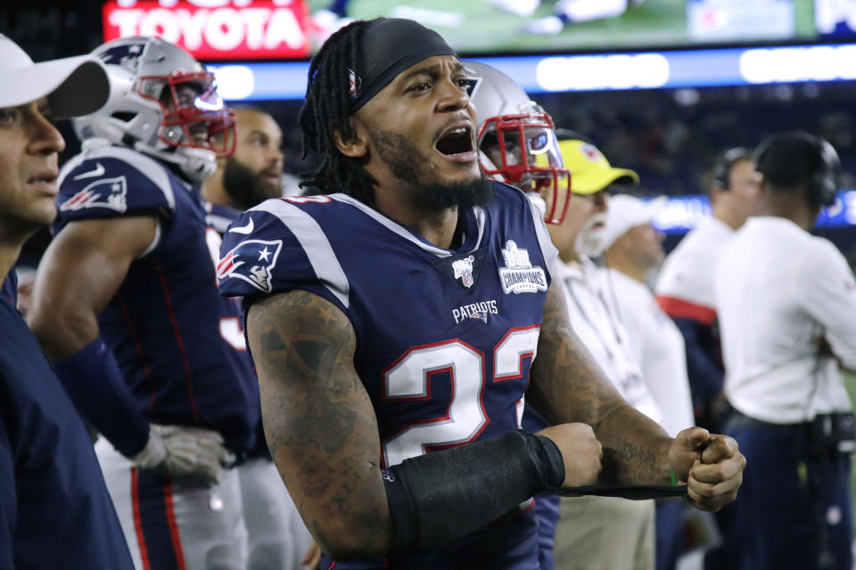 Patrick Chung yells from the sideline while wearing a blue Patriots uniform.