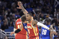 Atlanta Hawks guard Dejounte Murray (5) reacts after scoring a 3-pointer, next to Orlando Magic center Moritz Wagner during the second half of an NBA basketball game Wednesday, Nov. 30, 2022, in Orlando, Fla. (AP Photo/Phelan M. Ebenhack)