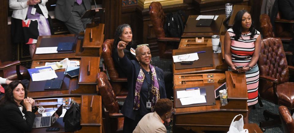 Rep. Cynthia Johnson, D-Detroit, middle, and Rep. Sarah Anthony, D-Lansing, right, react as pro-choice demonstrators rally above the floor from the gallery demanding legislators repeal the 1931 Michigan abortion ban. The event was organized by the Michigan Coalition for Reproductive Liberation.