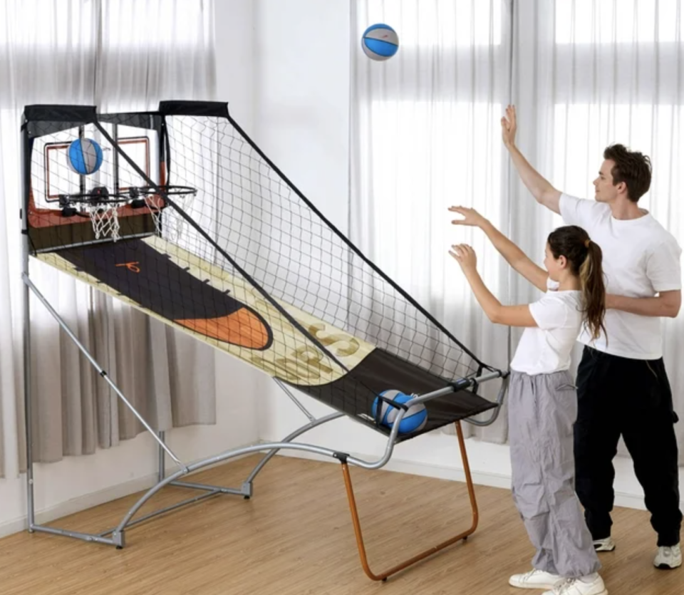 models playing with indoor basketball arcade