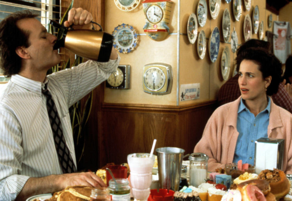 Phil chugging from a carafe of coffee as Rita looks on in shock