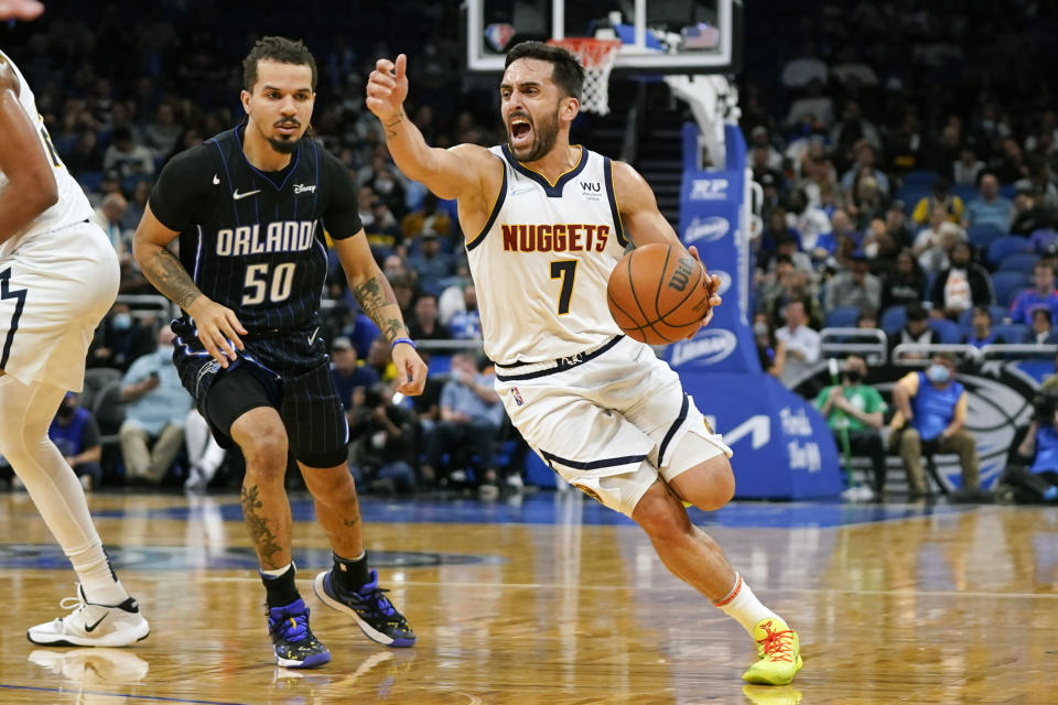 Denver Nuggets guard Facundo Campazzo (7) drives around Orlando Magic guard Cole Anthony (50) during the first half of an NBA basketball game, Wednesday, Dec. 1, 2021, in Orlando, Fla. (AP Photo/John Raoux)