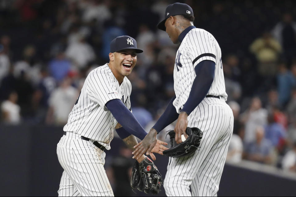 New York Yankees relief pitcher Aroldis Chapman, right, and shortstop Gleyber Torres celebrate after the Yankees defeated the Boston Red Sox 6-4 in the second baseball game of a doubleheader, Saturday, Aug. 3, 2019, in New York. (AP Photo/Kathy Willens)
