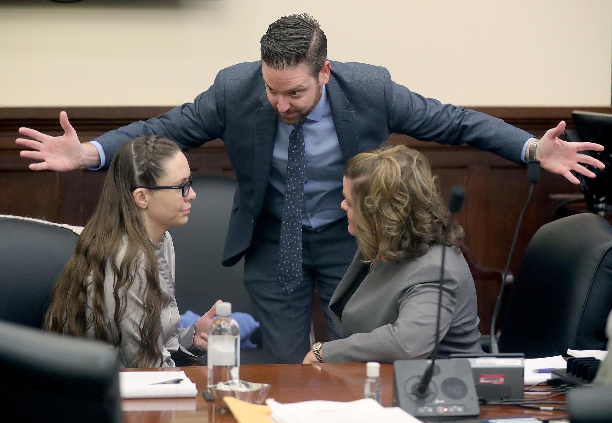 Defense attorneys Jeff Laybourne and Angie Kille (right) talk with Erica Stefanko (left) in Summit County Common Pleas Court on Tuesday, Jan. 16 before her retrial was set to start for her alleged role in the pizza delivery murder case. The start of the trial was delayed because of illness.