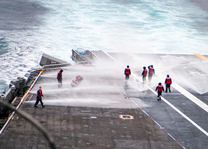 Sailors conduct a counter measure washdown on the flight deck of the aircraft carrier USS Nimitz Sept. 14.