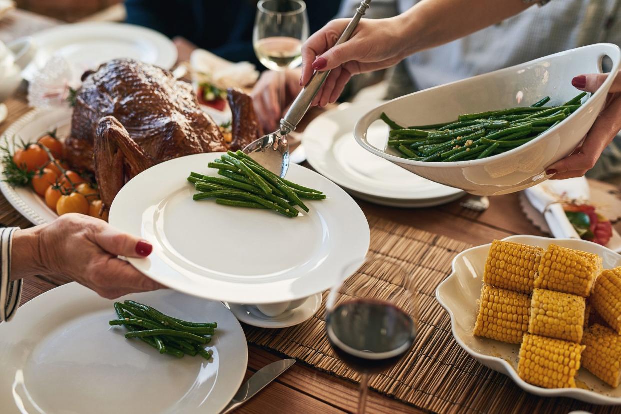 person being served green beans at dinner