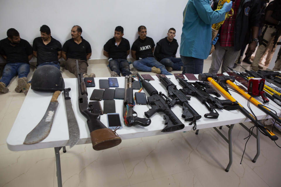 Suspects in the assassination of Haiti's President Jovenel Moise are shown to the media, along with the weapons and equipment they allegedly used in the attack, at the General Direction of the police in Port-au-Prince, Haiti, Thursday, July 8, 2021. Moise was assassinated in an attack on his private residence early Wednesday. (AP Photo / Joseph Odelyn)