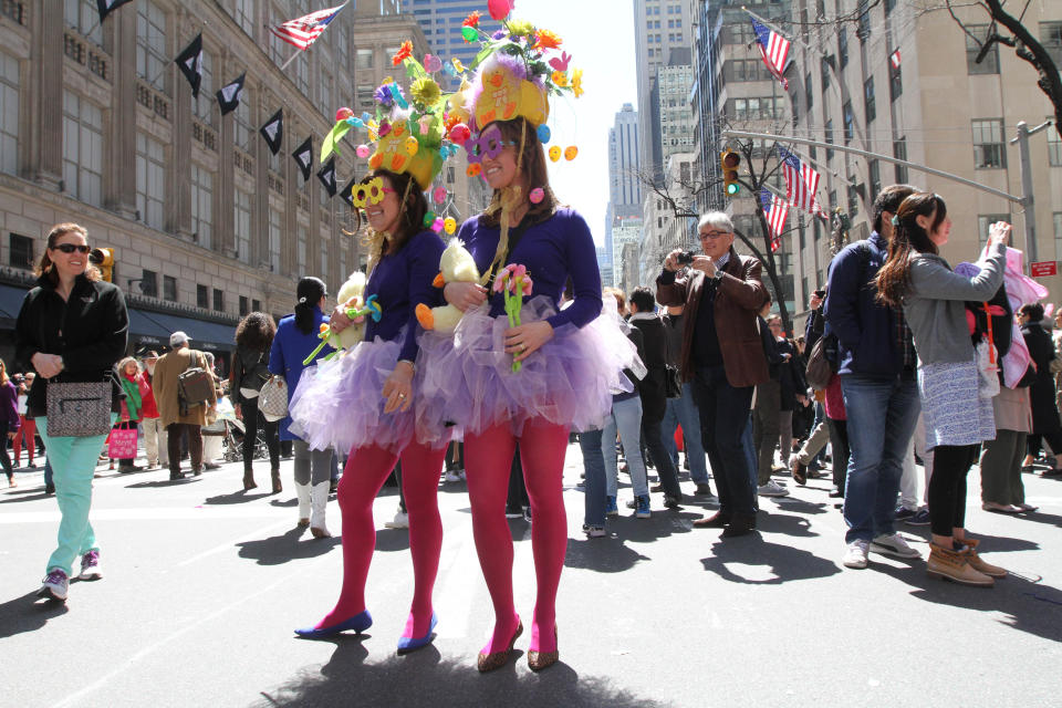 Dressed for the occasion, Karen Zandri, foreground left, and her daughter Paige Capala, foreground right, pose for photographs as they take part in the Easter Parade along New York's Fifth Avenue, Sunday, April 20, 2014. (AP Photo/Tina Fineberg)