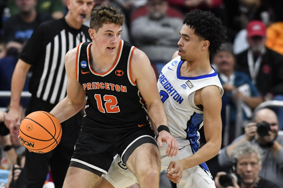 Princeton forward Caden Pierce (12) moves the ball against Creighton guard Ryan Nembhard (2) in the first half of a Sweet 16 round college basketball game in the South Regional of the NCAA Tournament, Friday, March 24, 2023, in Louisville, Ky. (AP Photo/Timothy D. Easley)