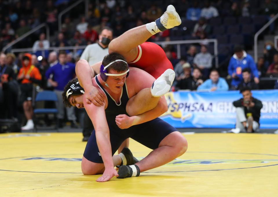 New Hartford/Sauquoit Valley's Charles Tibbits flips Sebastian Regis from Long Island during their 285-pound title bout Saturday at the NYSPHSAA wrestling championships at MVP Arena.