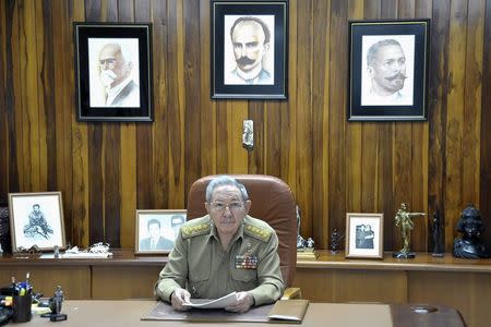 Cuba's President Raul Castro sits at a desk in his office in Havana in this December 16, 2014 picture provided by Estudios Revolucion. REUTERS/Estudios Revolucion/Handout via Reuters