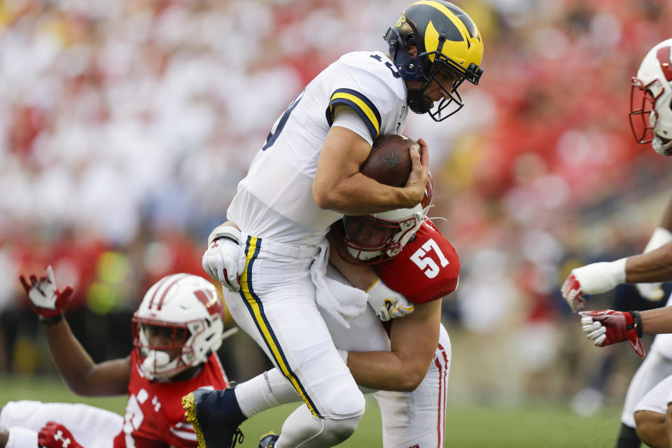 CORRECTS SCORE TO 35-14-Wisconsin linebacker Jack Sanborn (57) tackles Michigan quarterback Dylan McCaffrey during the second half of an NCAA college football game Saturday, Sept. 21, 2019, in Madison, Wis. Wisconsin won 35-14. (AP Photo/Andy Manis)