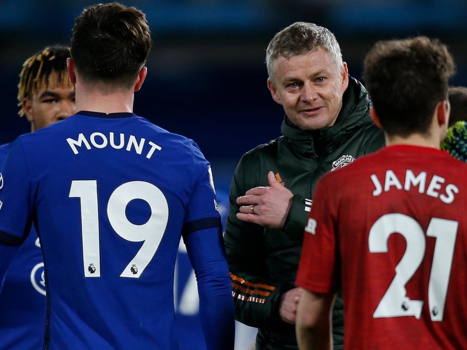 Ole Gunnar Solskjaer interacts with his players and Chelsea's at full-time (IKIMAGES/AFP via Getty Images)