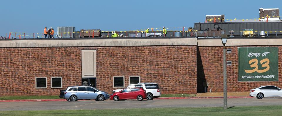 Crews work on the roof of the Noble Complex for Athletics at Oklahoma Baptist University.