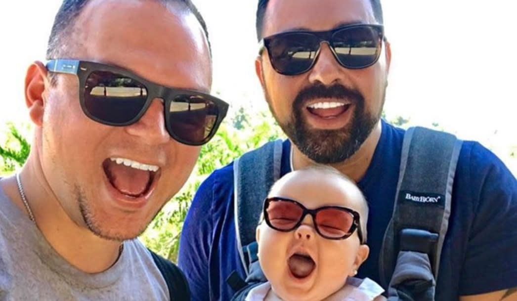 Dads Tommy and Rob with their daughter Mia. (Photo: Instagram/gays_with_kids)