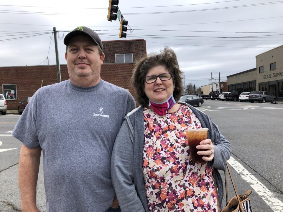 Freddie and Laurel Browning outside near a street and buildings.