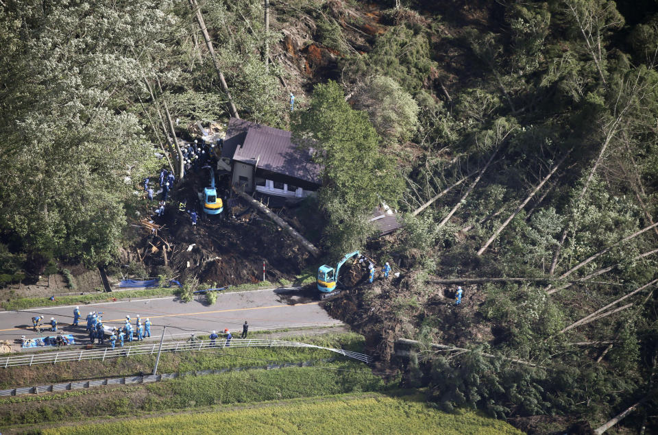 Police search missing persons at the site of a landslide after an earthquake in Atsuma town, Hokkaido, northern Japan, Thursday, Sept. 6, 2018. A powerful earthquake rocked Japan’s northernmost main island of Hokkaido early Thursday, triggering landslides that crushed homes, knocking out power across the island, and forcing a nuclear power plant to switch to a backup generator. (Kyodo News via AP)