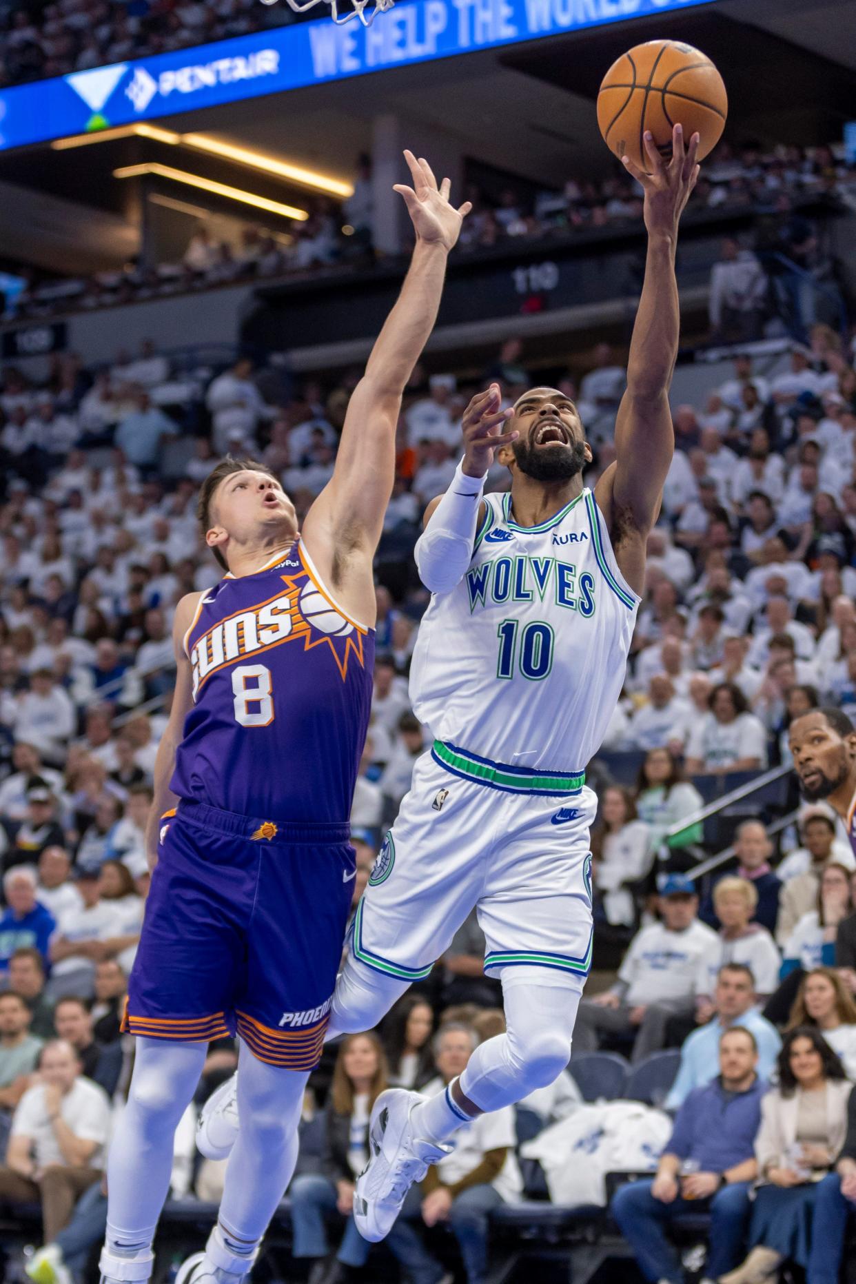 Apr 20, 2024; Minneapolis, Minnesota, USA; Minnesota Timberwolves guard Mike Conley (10) drives to the basket past Phoenix Suns guard Grayson Allen (8) in the second half during game one of the first round for the 2024 NBA playoffs at Target Center. Mandatory Credit: Jesse Johnson-USA TODAY Sports