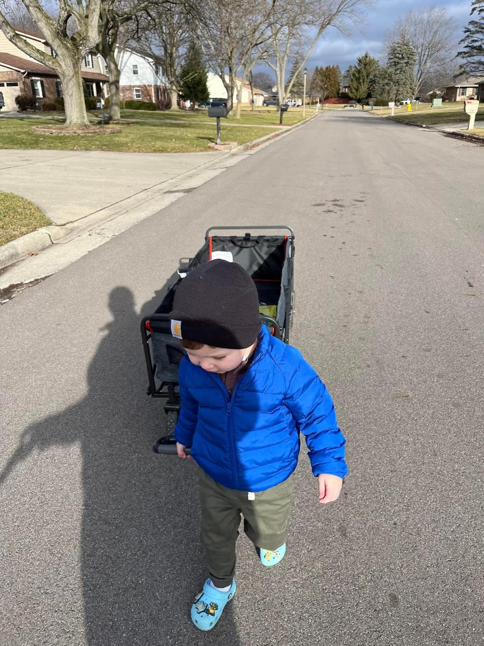 With help from his wagon, Edsel Bates delivers books to Little Free Libraries with grandma Lori Goins.