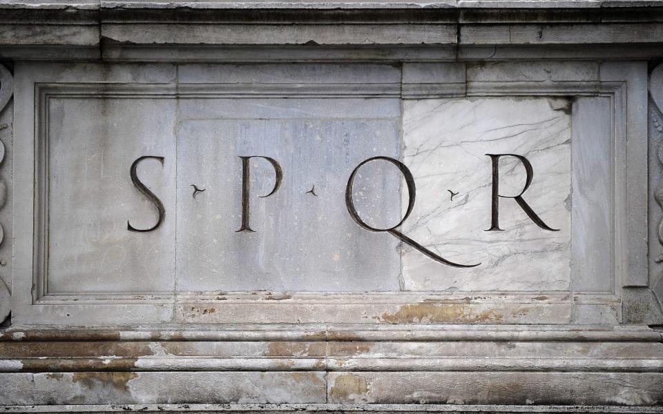 The Latin phrase Senatus Populusque Romanus (The Senate and the People of Rome), referring to the government of the ancient Roman Republic, on a monument in Rome - Getty