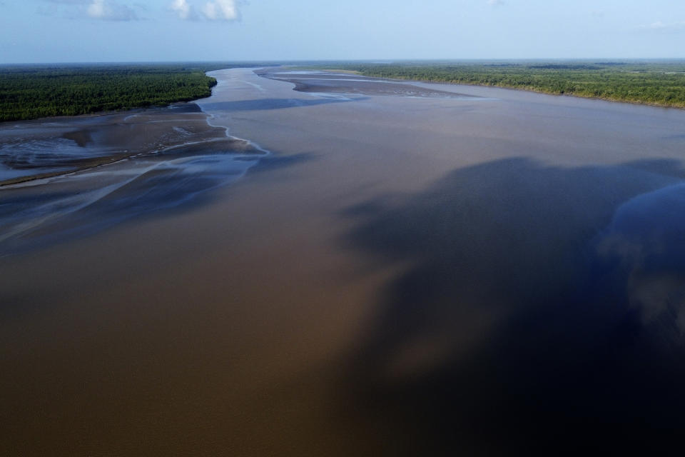 Water flows in at the point where the river meets the sea in the Bailique Archipelago, district of Macapa, state of Amapa, northern Brazil, Monday, Sept. 12, 2022. The Amazon River discharges one-fifth of all the world's freshwater that runs off land surface. Despite that force, the seawater pushed back the river that bathes the archipelago for most of the second half of 2021, leaving thousands scrambling for drinking water. (AP Photo/Eraldo Peres)