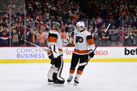 Philadelphia Flyers goaltender Samuel Ersson, left, and Travis Sanheim, right, celebrate after their victory in an NHL hockey game against the New Jersey Devils, Saturday, April 13, 2024, in Philadelphia. (AP Photo/Derik Hamilton)