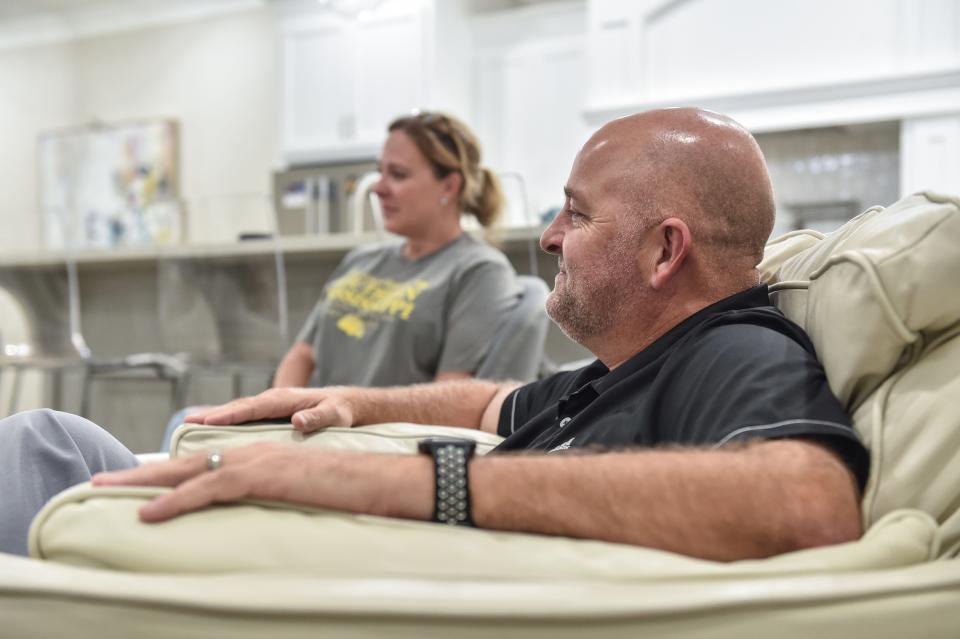 Hank and Melinda Lott are seen at home in Hattiesburg, Miss., Monday, August 22, 2022. Their son, Stone, works as a volunteer equipment manager with Southern Miss football.