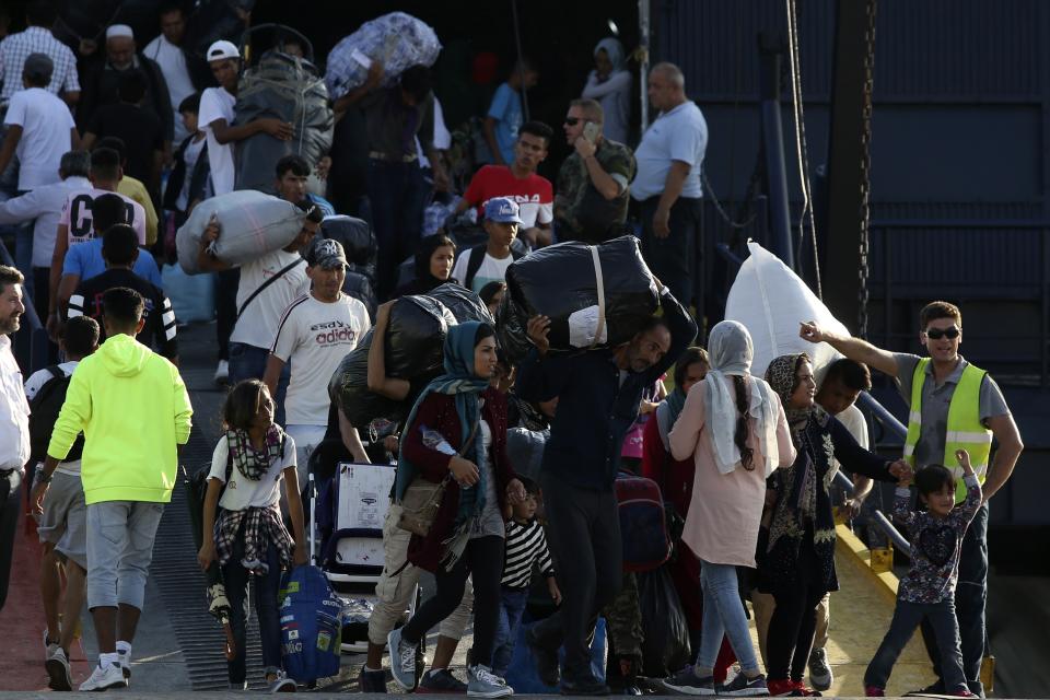 Refugees and migrants arrive at the port of Thessaloniki, northern Greece, Monday, Sept. 2, 2019. About 1,500 asylum-seekers were being transported from Greece's eastern Aegean island of Lesbos to the mainland Monday as part of government efforts to tackle massive overcrowding in refugee camps and a recent spike in the number of people arriving from the nearby Turkish coast. (AP Photo/Giannis Papanikos)