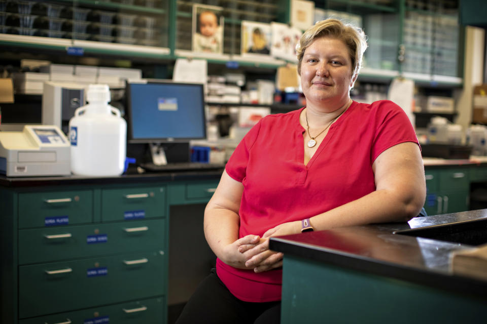 This Aug. 14, 2019 photo provided by the University of Kentucky shows Donna Wilcock, of the Sanders-Brown Center on Aging in her lab in Lexington, Ky. She says that contrary to popular perception, "there are a lot of changes that happen in the aging brain that lead to dementia in addition to plaques and tangles." (Mark Cornelison/University of Kentucky via AP)