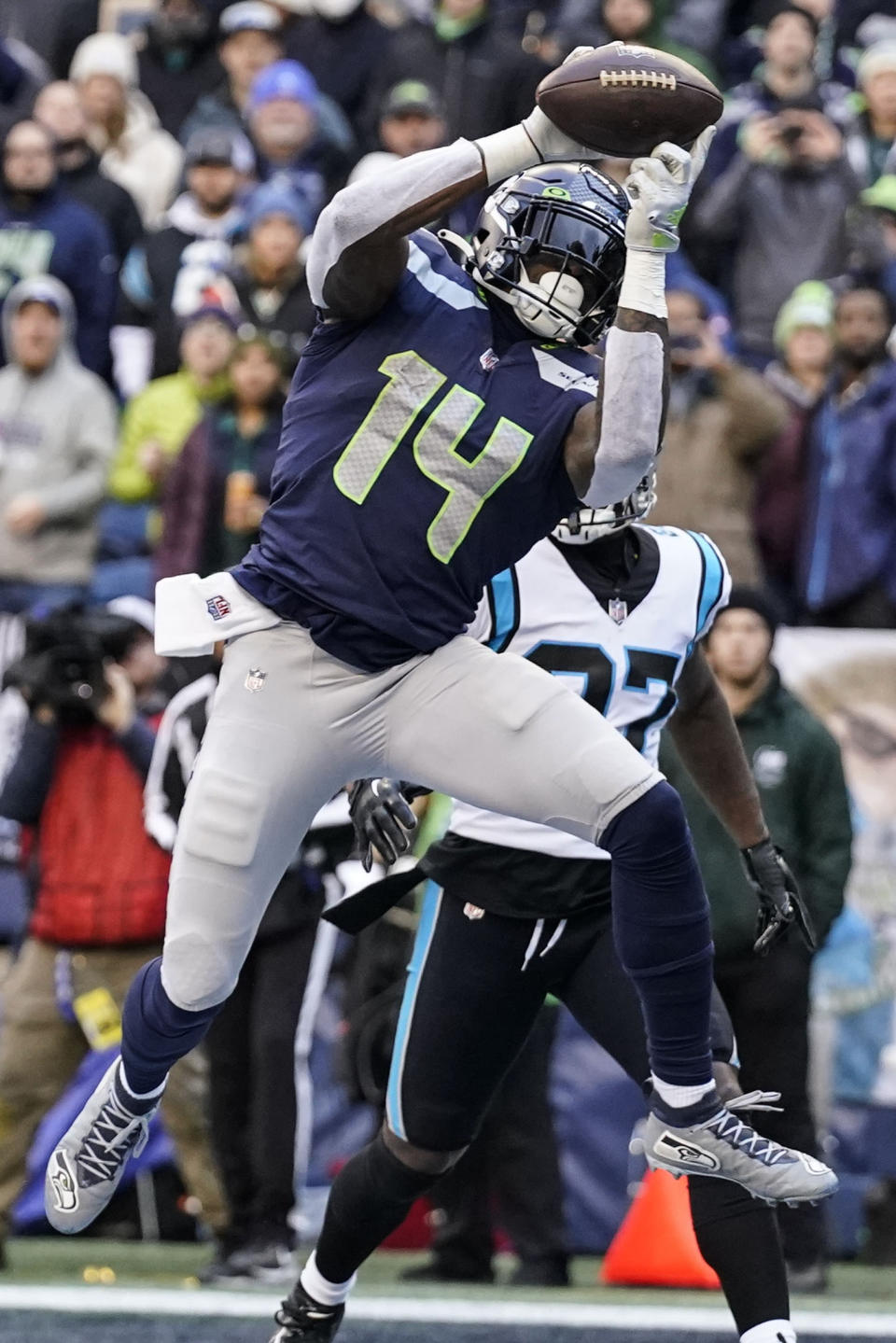 Seattle Seahawks wide receiver DK Metcalf (14) makes a touchdown catch against Carolina Panthers cornerback T.J. Carrie (27) during the first half of an NFL football game, Sunday, Dec. 11, 2022, in Seattle. (AP Photo/Gregory Bull)