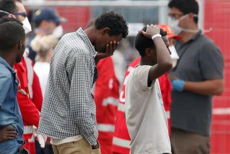 Migrants rest after disembarking in the Sicilian harbour of Catania, Italy, May 28, 2016. REUTERS/Antonio Parrinello