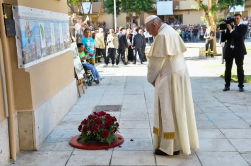 Pope Francis laid a wreath of flowers outside the modest Palermo home of Father Giuseppe Puglisi who was murdered here by the mob in 1993