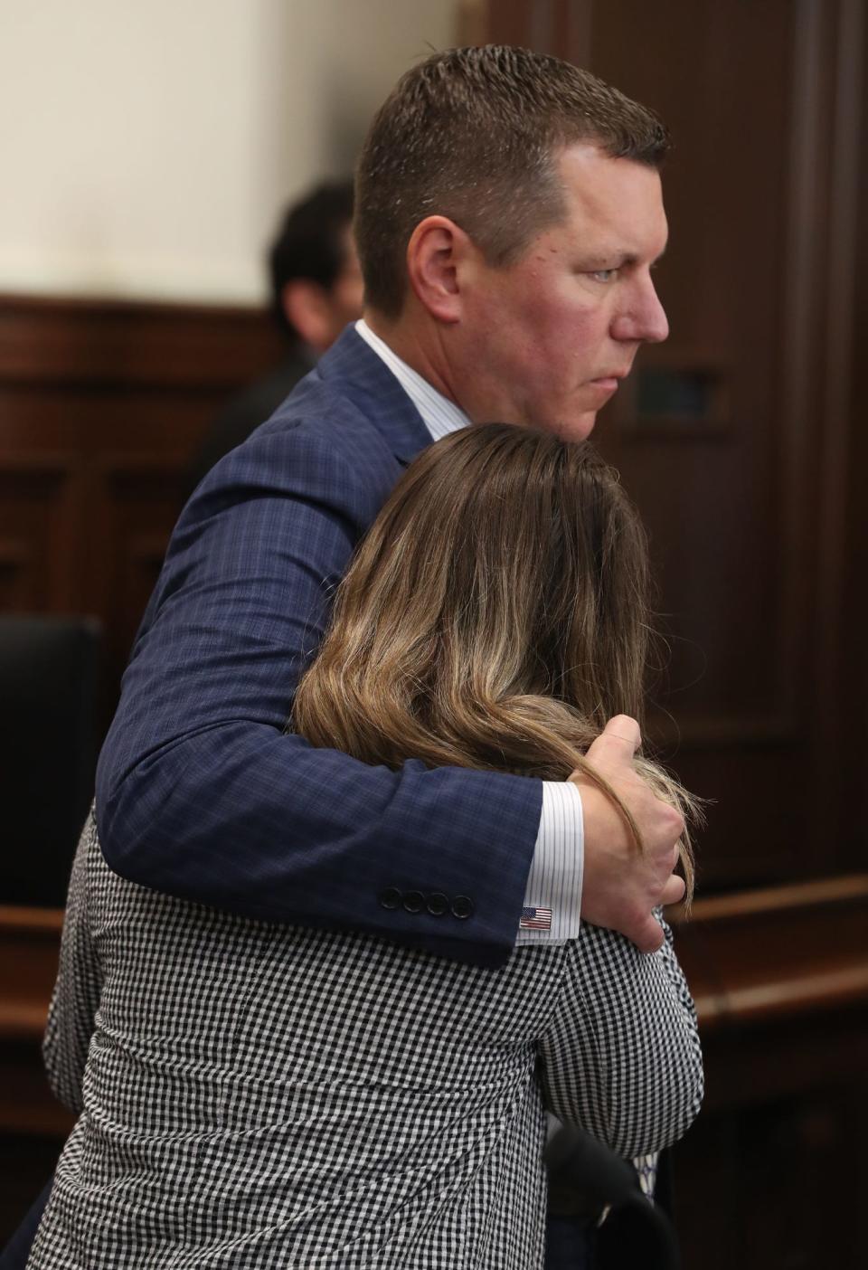 Defense attorney Don Malarcik comforts Sydney Powell after being found guilty verdict for the stabbing death of her mother after her trial in Summit County Common Pleas Judge Kelly McLaughlin's courtroom.