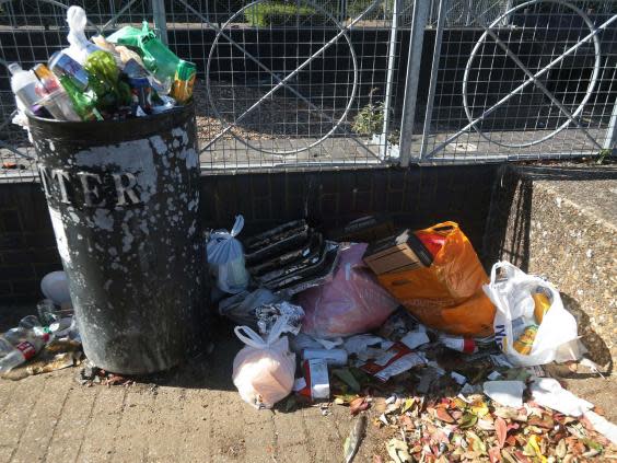 A pile of used disposable barbecues next to a litter bin on the Isle of Dogs, London, after the introduction of measures to bring the country out of lockdown. (Yui Mok/PA)