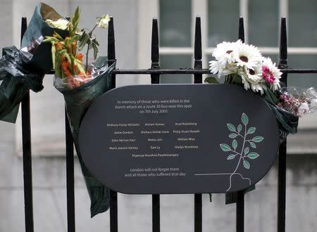 A memorial plaque is attached to railings in Tavistock Square, in memory of those who lost their lives on a number 30 double-decker bus during the 7/7 attack in 2005, in London, July 6, 2015. REUTERS/Peter Nicholls