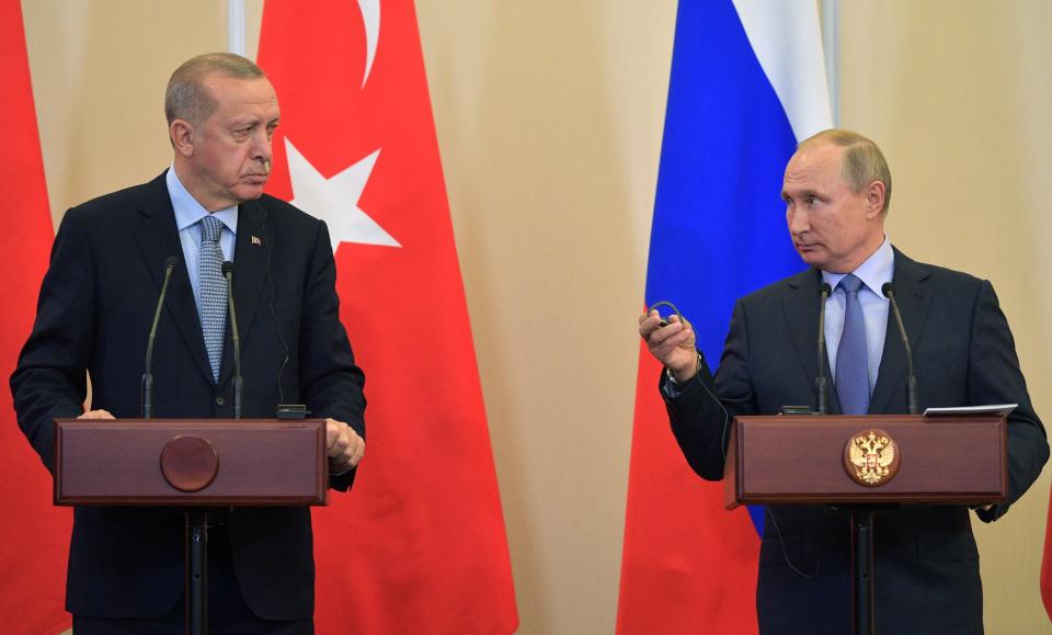 Russian President Vladimir Putin, right, and Turkish President Recep Tayyip Erdogan look at each other during a joint news conference after their talks in the Bocharov Ruchei residence in the Black Sea resort of Sochi, Russia, Tuesday, Oct. 22, 2019. Erdogan says Turkey and Russia have reached a deal in which Syrian Kurdish fighters will move 30 kilometers (18 miles) away from a border area in northeast Syria within 150 hours. (Alexei Druzhinin/Sputnik Kremlin Pool Photo via AP)