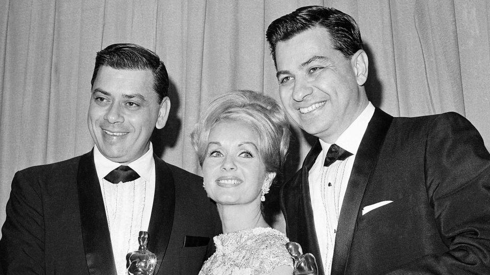 Actress Debbie Reynolds poses with Academy Awards winners for best music Richard M. Sherman, right, and Robert Sherman, left, who received the award for "Mary Poppins" in Santa Monica, Calif., April 5, 1965. - AP