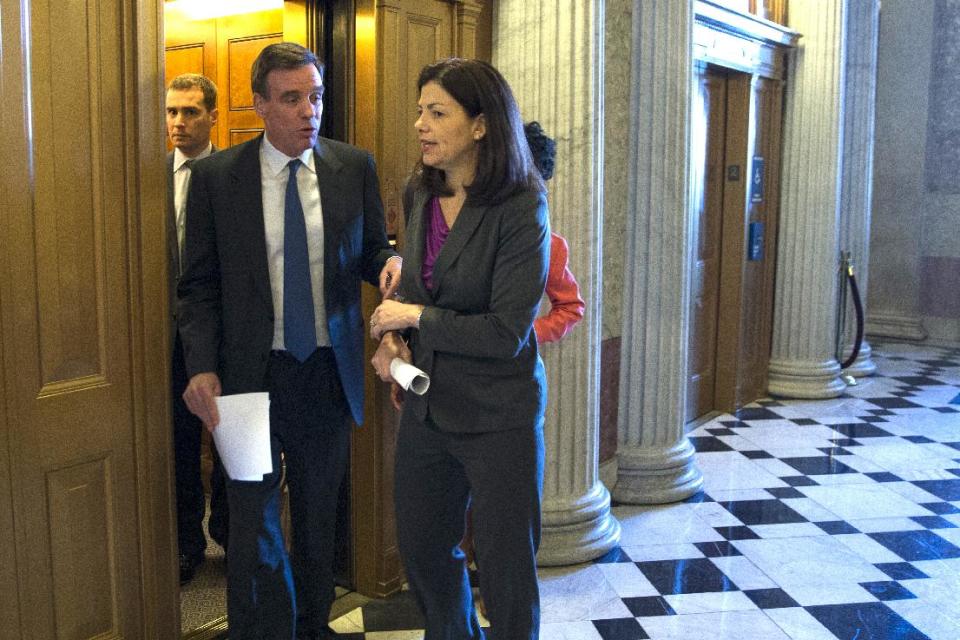 Sen. Kelly Ayotte, R-N.H., right, and Sen. Mark Warner, D-Va., arrive for a Senate vote on military sexual assault legislation on Capitol Hill on Monday, March 10, 2014, in Washington. (AP Photo/ Evan Vucci)