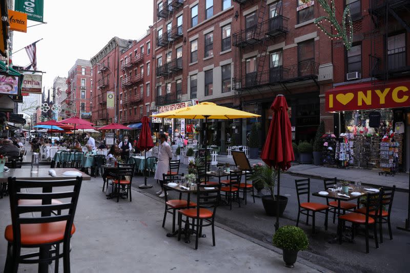 People dine outside on Mulberry Street in lower Manhattan