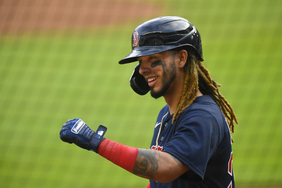 Boston Red Sox's Jonathan Arauz celebrates a solo home run against the Atlanta Braves as he enters the dugout during the ninth inning of a baseball game Sunday, Sept. 27, 2020, in Atlanta. (AP Photo/John Amis)