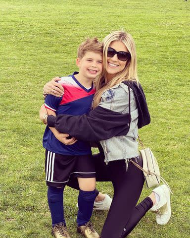 <p>Christina Hall Instagram</p> Christina Hall hugging her son Brayden El Moussa during a soccer game