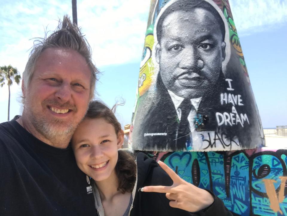 Artist Shane Grammer poses with his daughter, Elliana, in front of his mural of Martin Luther King, Jr. in Venice Beach.