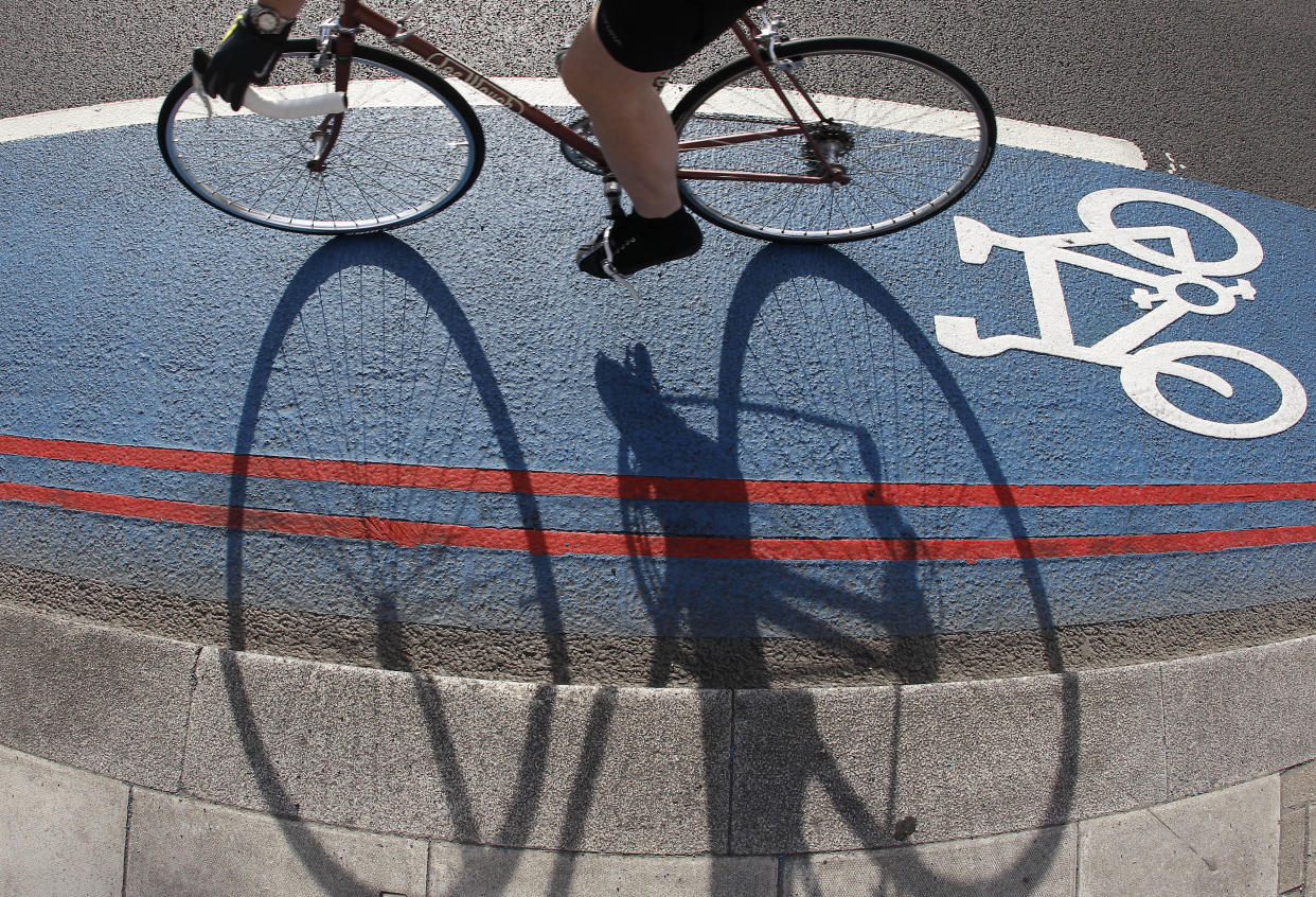 A cyclist uses a new Cycle Superhighway during rush hour in London July 9, 2010. The new blue-painted cycle routes will form another commuter route in central London and aim to increase cycling in Britain's capital.   REUTERS/Stefan Wermuth (BRITAIN - Tags: SPORT CYCLING TRANSPORT IMAGES OF THE DAY)