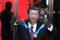 Chinese President Xi Jinping, left, receives the order of South Africa from President Cyril Ramaphosa at Union Building in Pretoria, South Africa, Tuesday, Aug. 22, 2023. Jinping has arrived for a state visit in South Africa where the two countries are expected to strengthen ties ahead of the BRICS summit starting in Johannesburg on Tuesday. (AP Photo/Themba Hadebe)