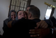 Relatives of Palestinian Naji Zaanin, 25, who was killed in a morning Israeli airstrike, mourn in the family home during his funeral in town of Beit Hanoun, northern Gaza Strip, Wednesday, Oct. 17, 2018. (AP Photo/ Khalil Hamra)