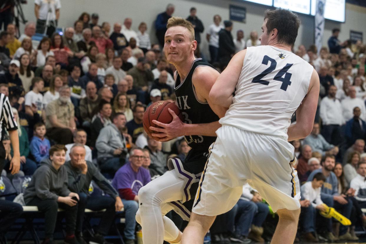 USF's Drew Guebert (23) dribbles the ball past Augustana's Michael Schaefer (24) during a game, Friday, Feb. 22, 2019 in Sioux Falls, S.D.