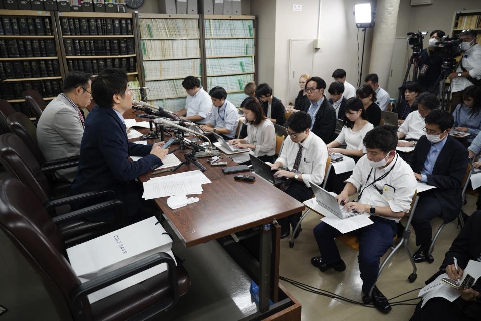 Lawyers of a claimant, Kazuyuki Minami, left, and Masafumi Yoshida, right, speak to media after the ruling of the Supreme Court Wednesday, Oct. 25, 2023, in Tokyo. Japan’s Supreme Court on Wednesday ruled that a law requiring transgender people to have sterilization surgery in order to officially change their gender is unconstitutional.(AP Photo/Eugene Hoshiko)